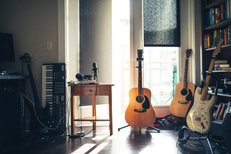 Acoustic guitars beside a window
